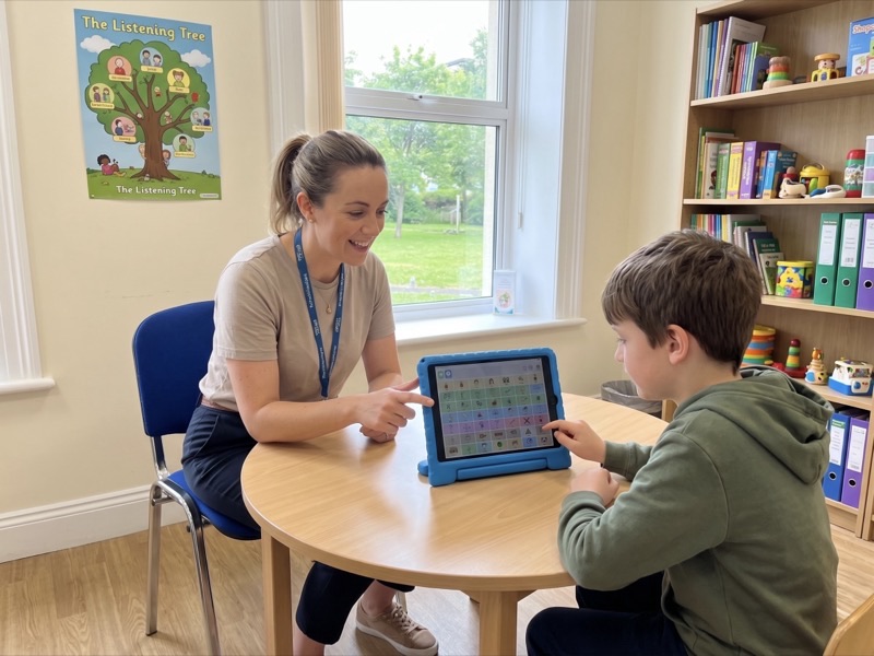 A speech therapist using SpeakPad with a young child